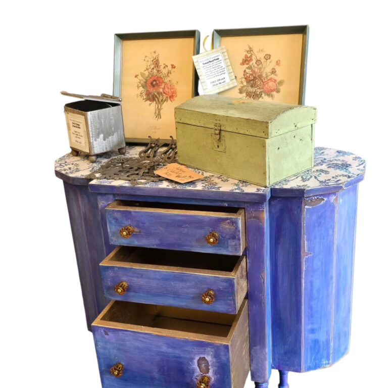 Antique Martha Washington Sewing Table, a symbol of heritage, reimagined in Blue Jean Baby with amber pulls, fiber paper decoupage, and funky gold drawers. Lots of room for your crocheting, sewing and knitting accoutrements. $275